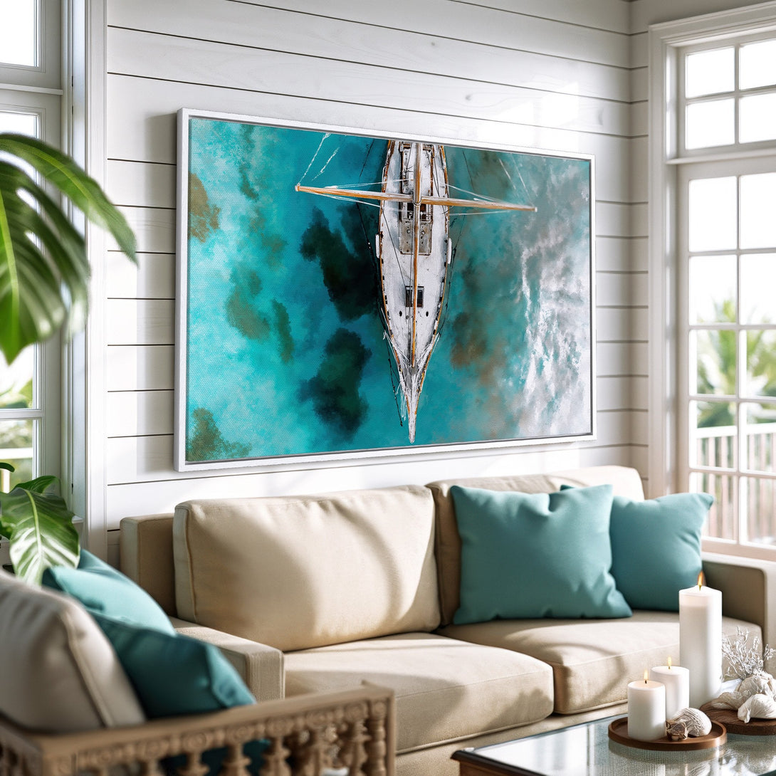 Framed Wall Art featuring a sailboat over turquoise water. Coastal style decor with a calming blue and white color palette, perfect for any living room.