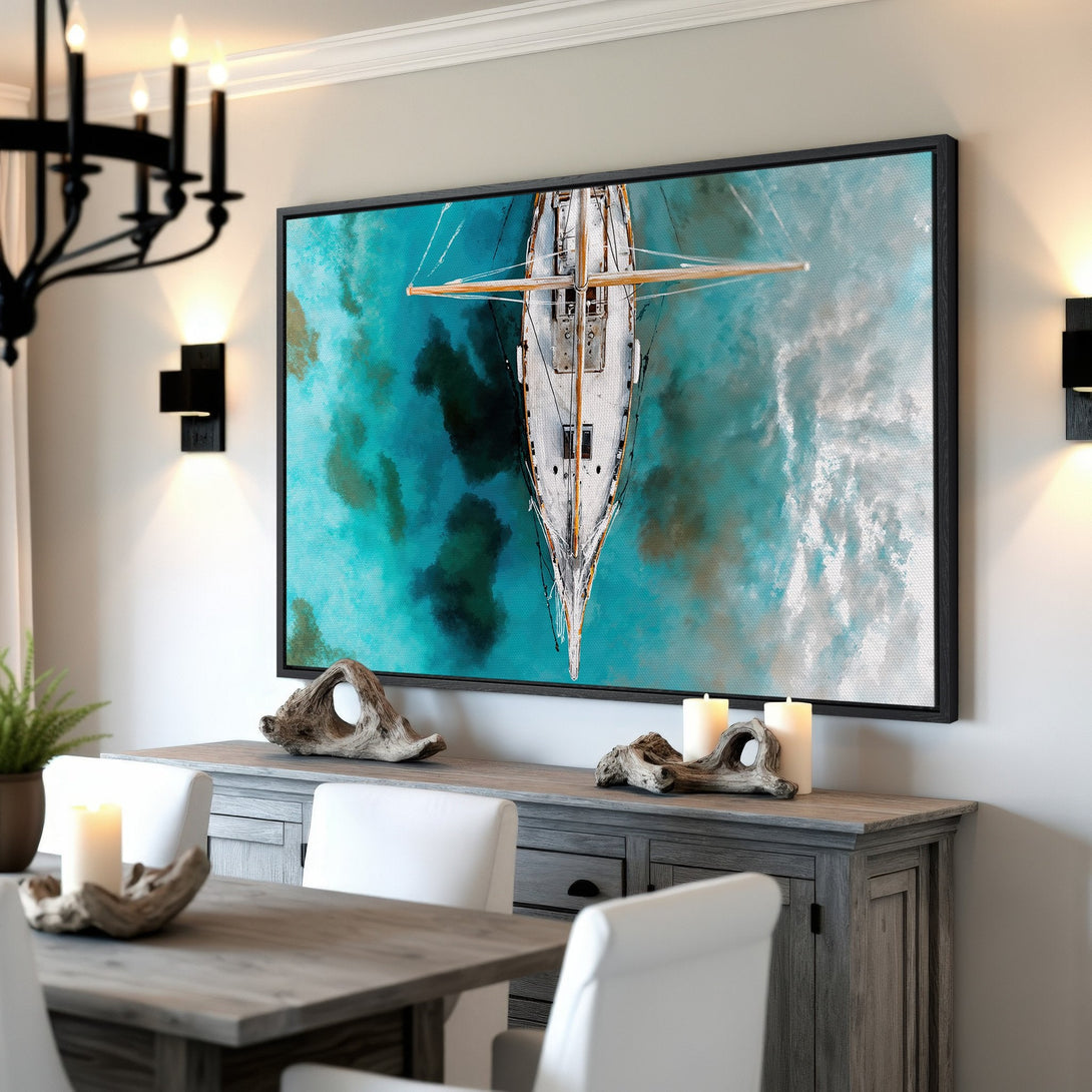 Framed Wall Art of a sailboat on turquoise water. Coastal style art with a blue and white color palette. Perfect for your home decor!