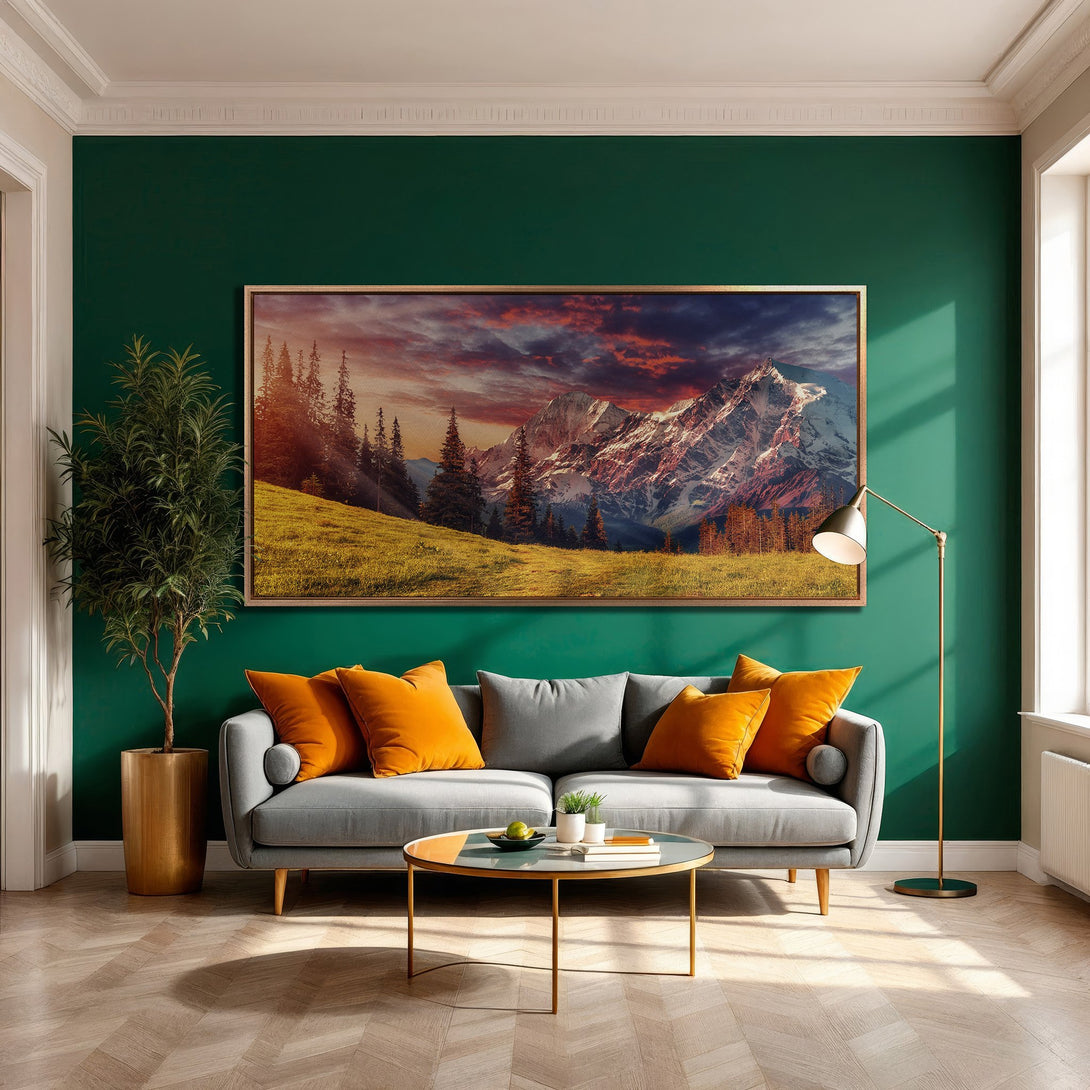 Framed Wall Art: Mountain landscape Canvas Print in a modern living room. Features a warm color palette with orange, green, and gold accents.