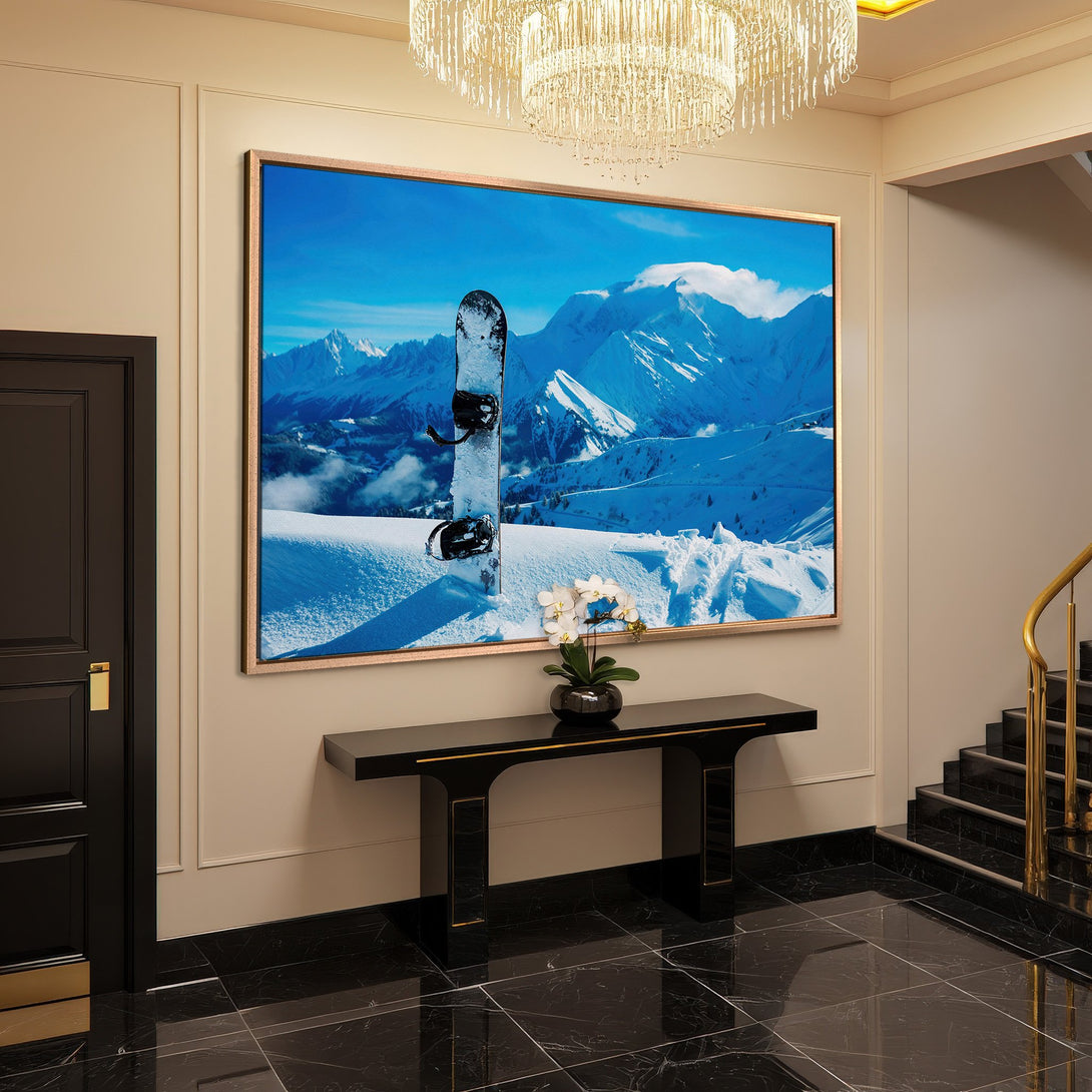 Framed Wall Art featuring a snowboard against a snowy mountain landscape. Blue and white color palette, perfect for adding a touch of adventure to your home.