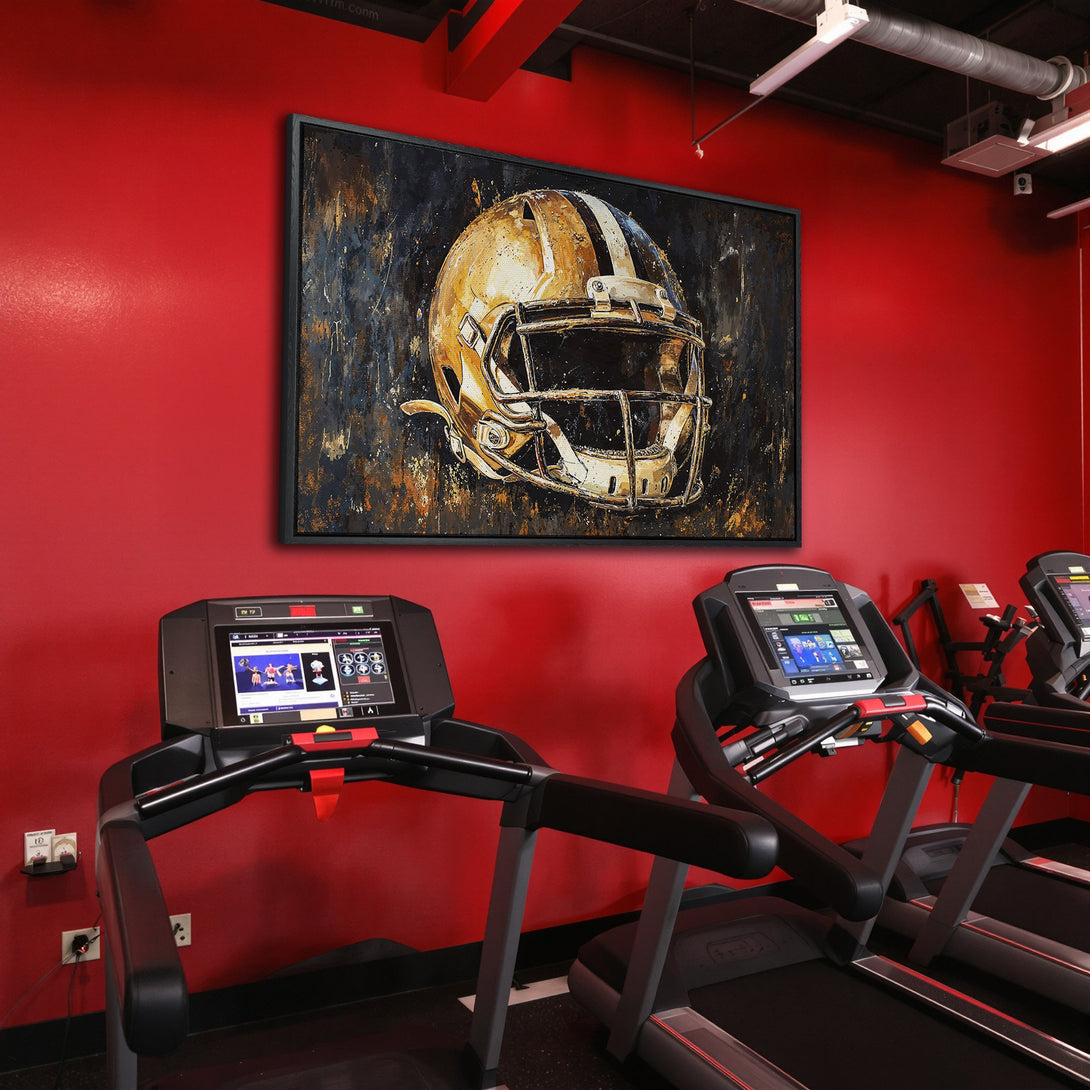Framed Wall Art: Abstract football helmet art in gold & black, displayed in a gym with red walls. Elevate your space with stylish wall decor!