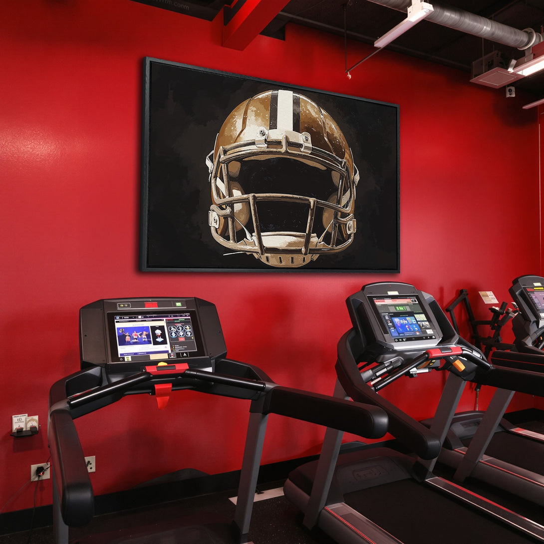 Framed Wall Art: Football helmet art in a gym setting. Modern canvas print with neutral tones against a vibrant red wall. Perfect for sports fans.