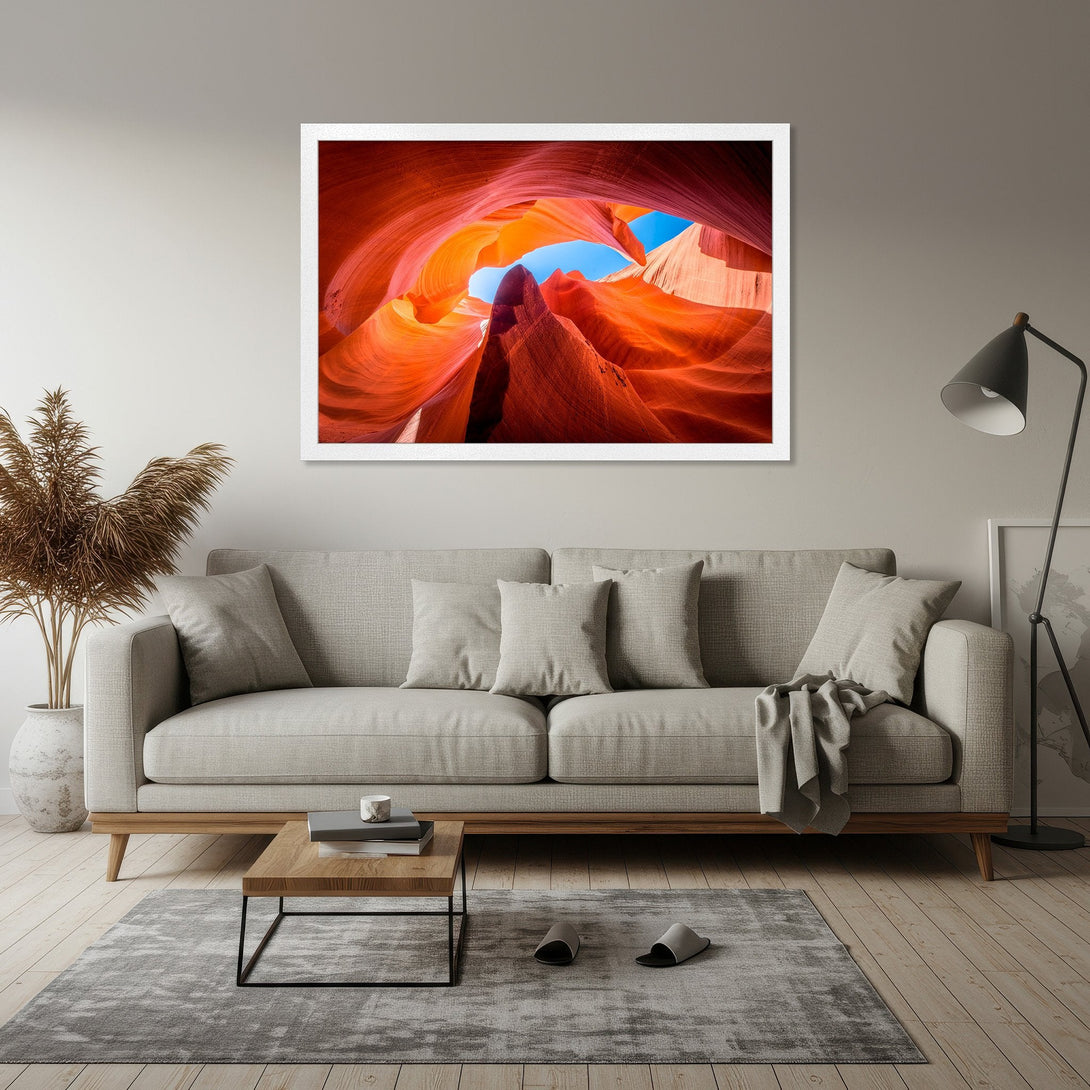 Framed Poster featuring stunning Antelope Canyon landscape art. Vibrant orange and red hues with a touch of blue sky. Perfect wall decor!