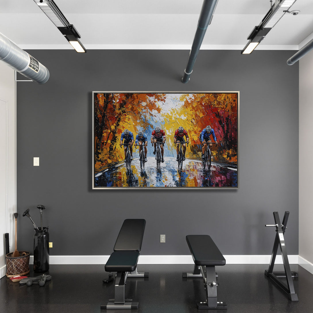 Framed Wall Art: Cyclists racing through a vibrant autumn landscape. Impressionistic style with warm orange, yellow, and blue hues. Perfect for home or gym decor.