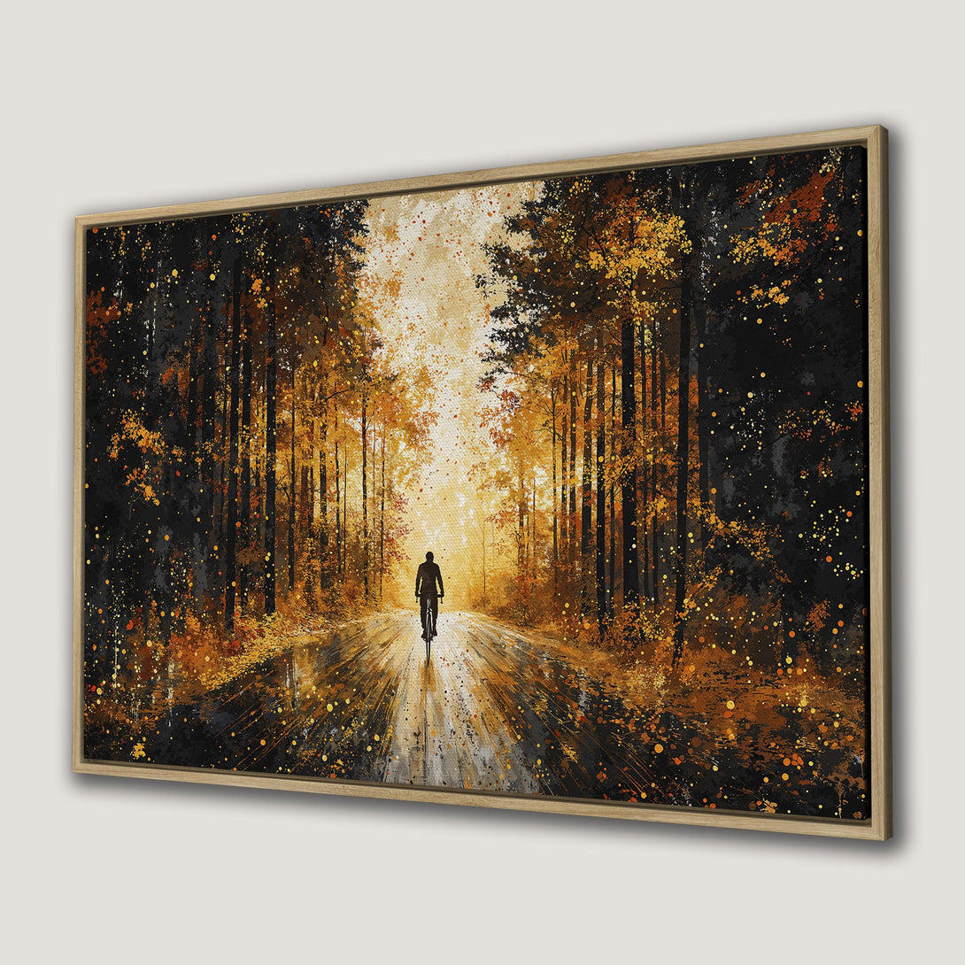 Framed Wall Art of a cyclist in a forest with warm orange and black tones. Perfect for adding a touch of nature to your home decor.