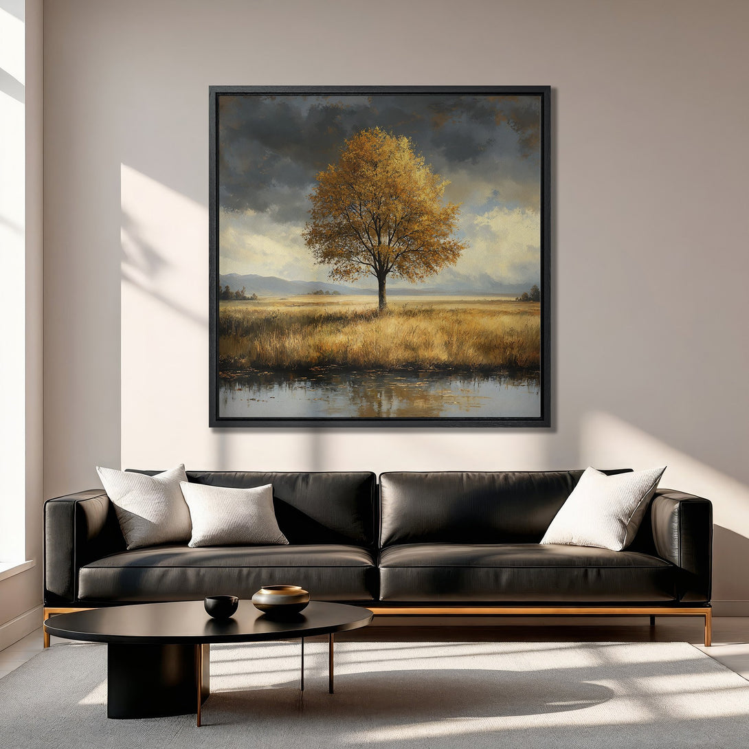 Framed Wall Art: Landscape Canvas Print of a golden tree in a field, displayed in a modern living room. Warm, earthy tones create a cozy aesthetic.