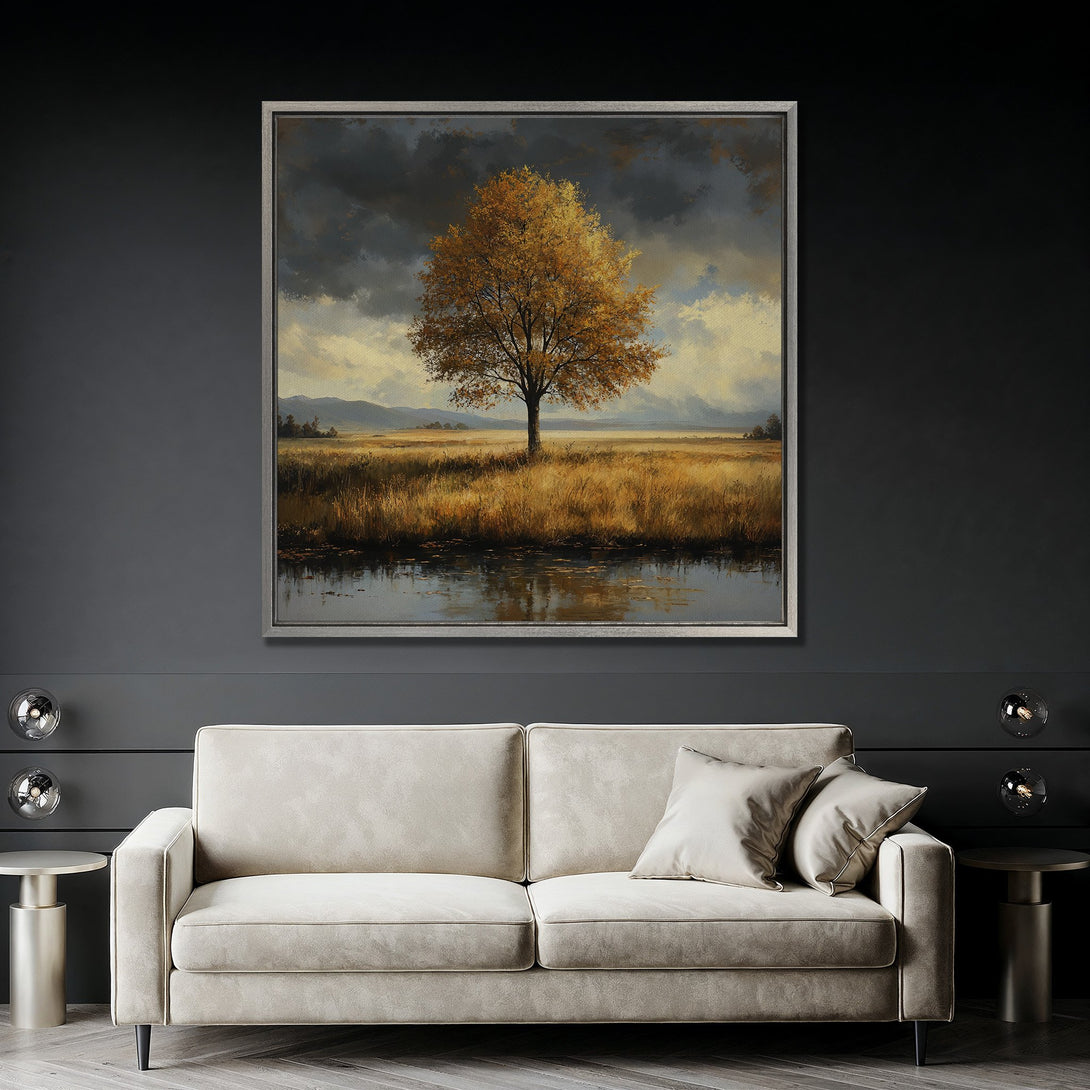 Framed Wall Art: Landscape Canvas Print with a golden tree and moody sky. Earthy color palette adds warmth to any room. Shop now for stunning wall decor!