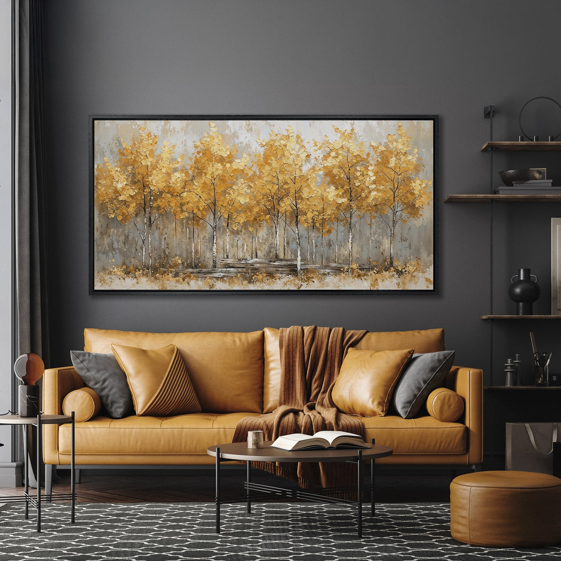 Framed Wall Art: Golden trees painting in a modern living room. Warm gold and gray color palette. Elevate your space with this stylish art piece.