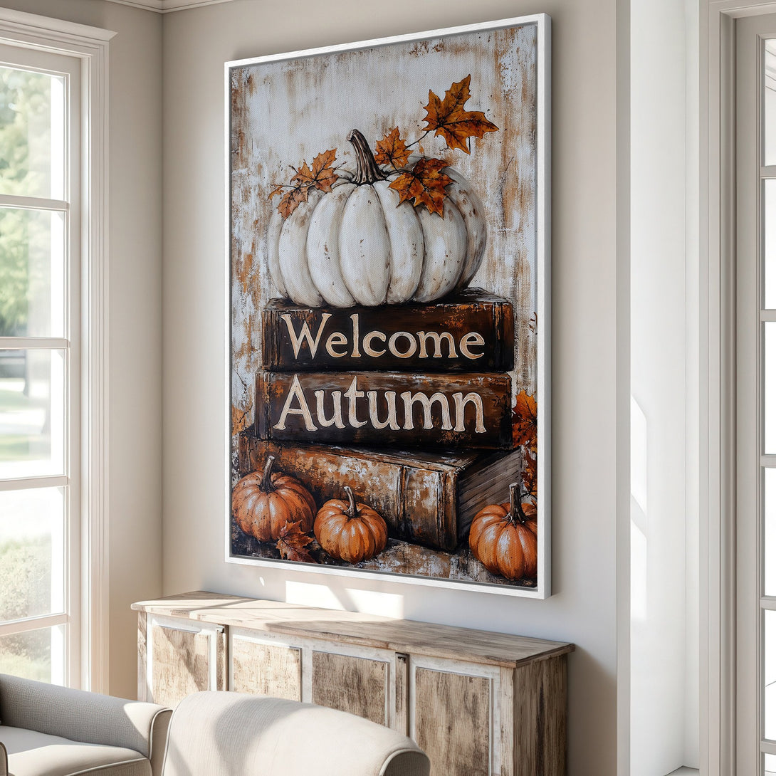Framed Wall Art: "Welcome Autumn" pumpkin print in warm tones. Rustic style canvas print with white, orange, and brown color palette, perfect for fall decor.