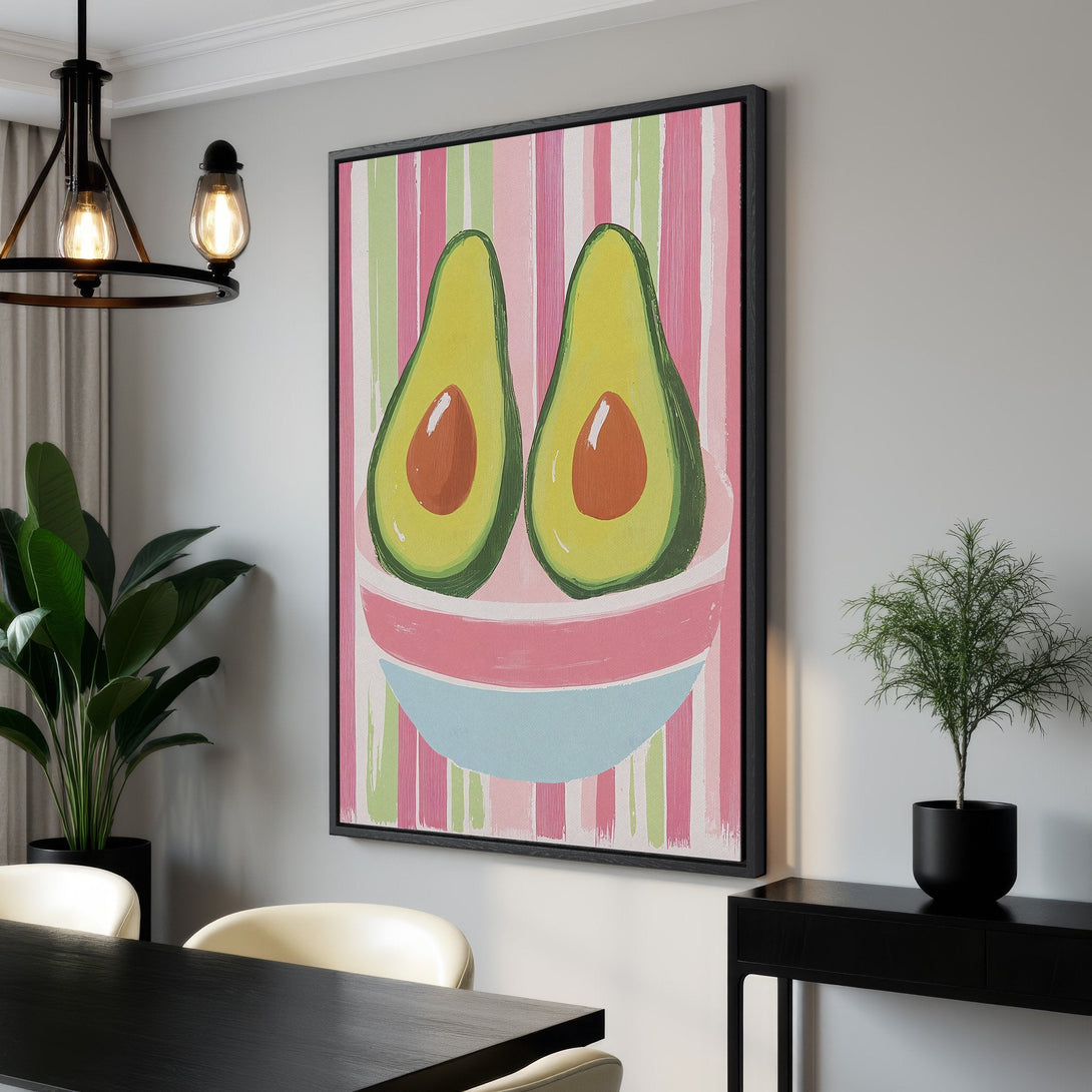 Framed Wall Art featuring a vibrant avocado painting with a playful, modern style and a colorful pink, green, and blue palette; perfect kitchen decor.