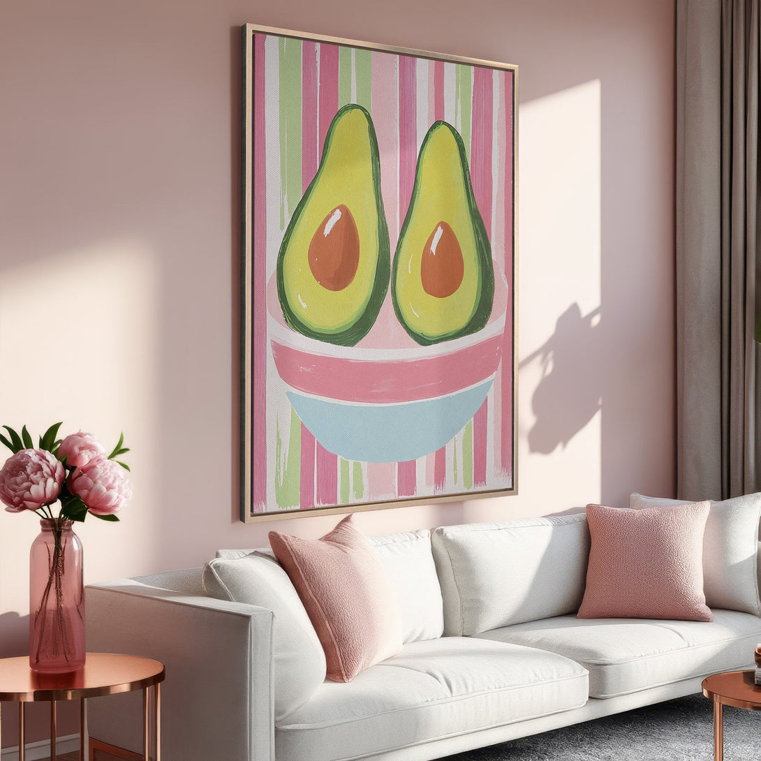 Framed Wall Art featuring a whimsical avocado painting in a pastel pink and green color palette, perfect for adding a pop of fun to your home decor.
