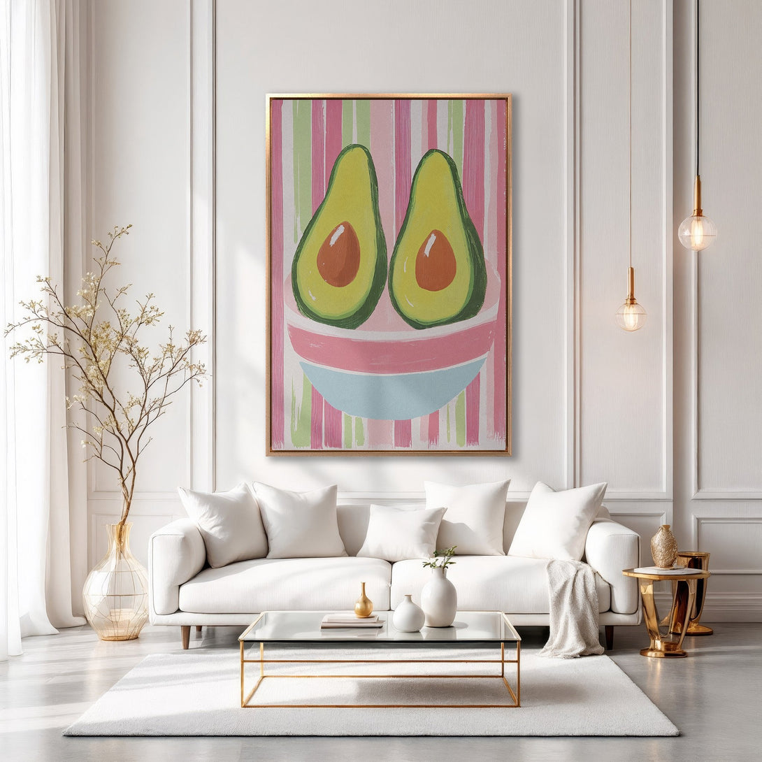 Framed Wall Art featuring a whimsical avocado painting in a modern interior. Pink, green, and gold color palette. Perfect for kitchen or dining room decor.