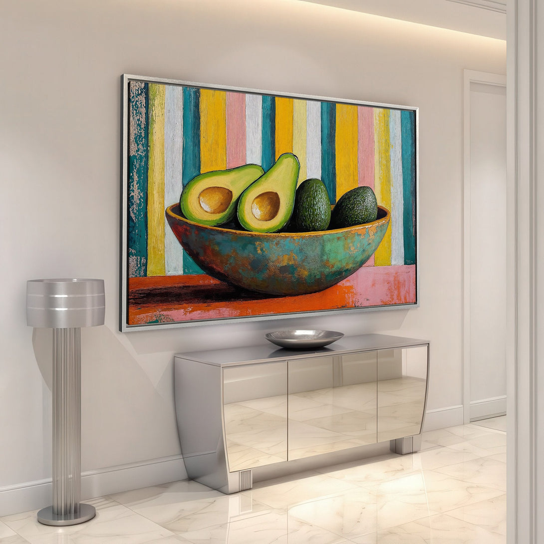Framed Wall Art featuring a vibrant avocado still life painting with a colorful striped background. Modern art with a bright, warm color palette for stylish home decor.