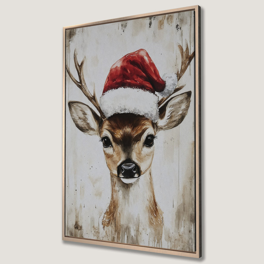 Framed Wall Art: Watercolor painting of a deer wearing a Santa hat. Neutral tones with pops of red create a festive, rustic holiday aesthetic.