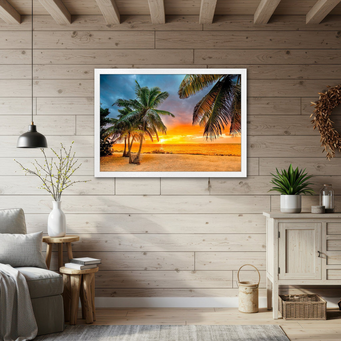 Framed Poster of a tropical sunset with palm trees. Coastal style art with warm orange and blue tones. Perfect wall decor.