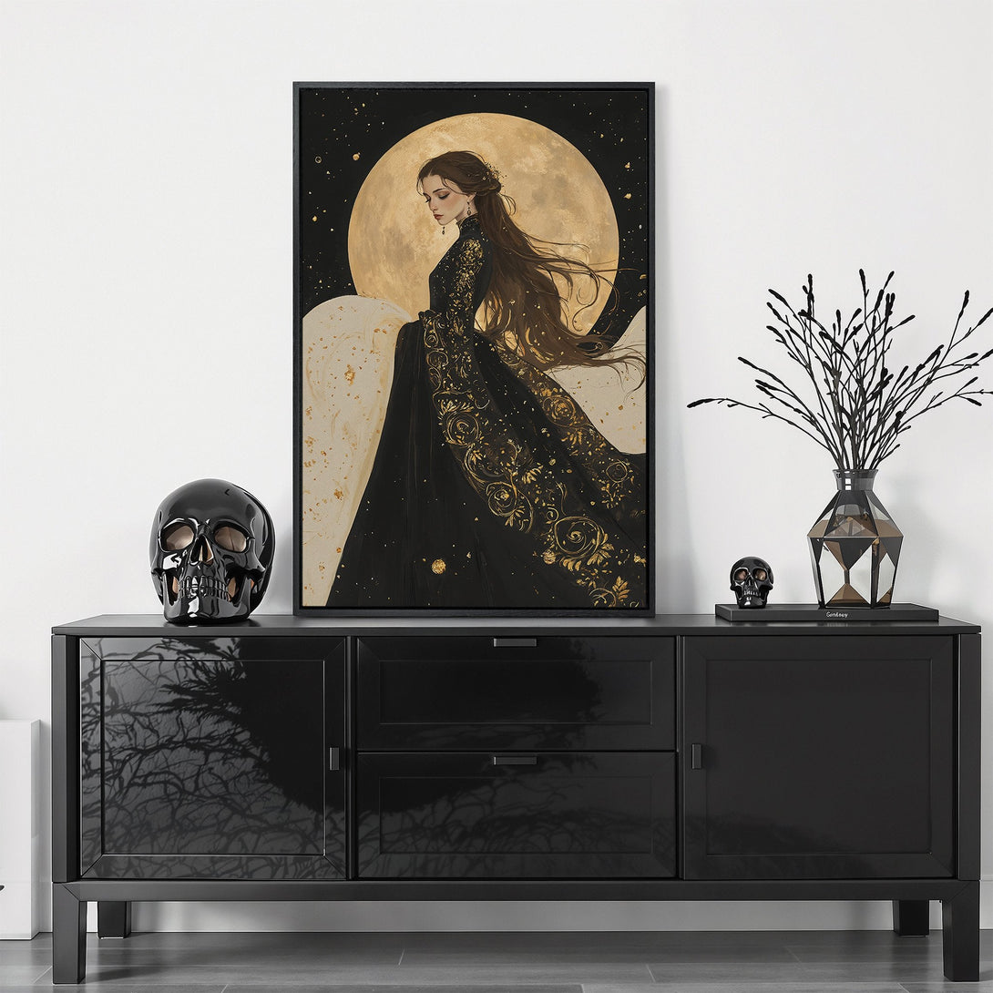 Framed Wall Art featuring a woman in a black and gold dress against a moon backdrop. Elegant and mysterious style, with a dark, moody color palette.