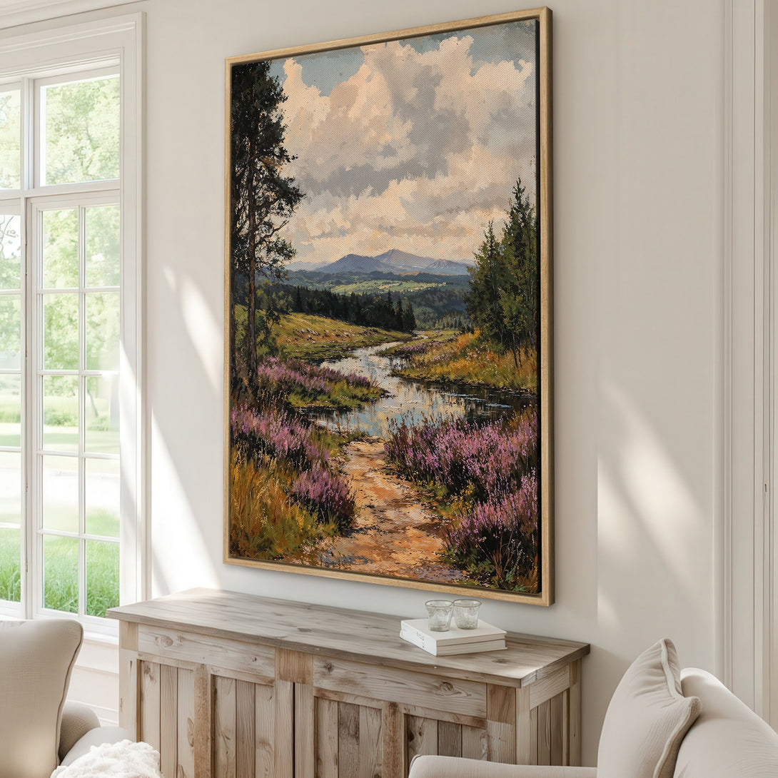 Framed Wall Art featuring a serene landscape painting with a river, purple flowers, and mountains in a warm color palette. Perfect for adding a touch of nature to your home!