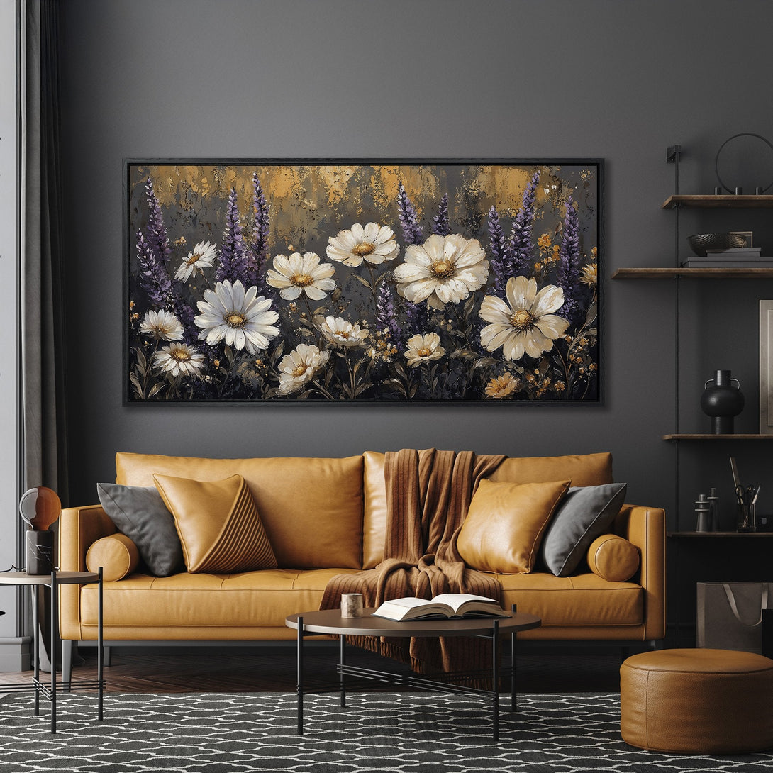 Framed Wall Art: Floral canvas print in a modern living room. Features white daisies and purple flowers with a moody color palette. Elevate your space!