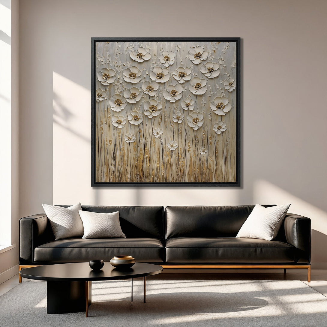 Framed Wall Art: Textured floral canvas print in neutral tones. Modern art with gold accents, displayed above a black leather sofa. Elegant home decor.