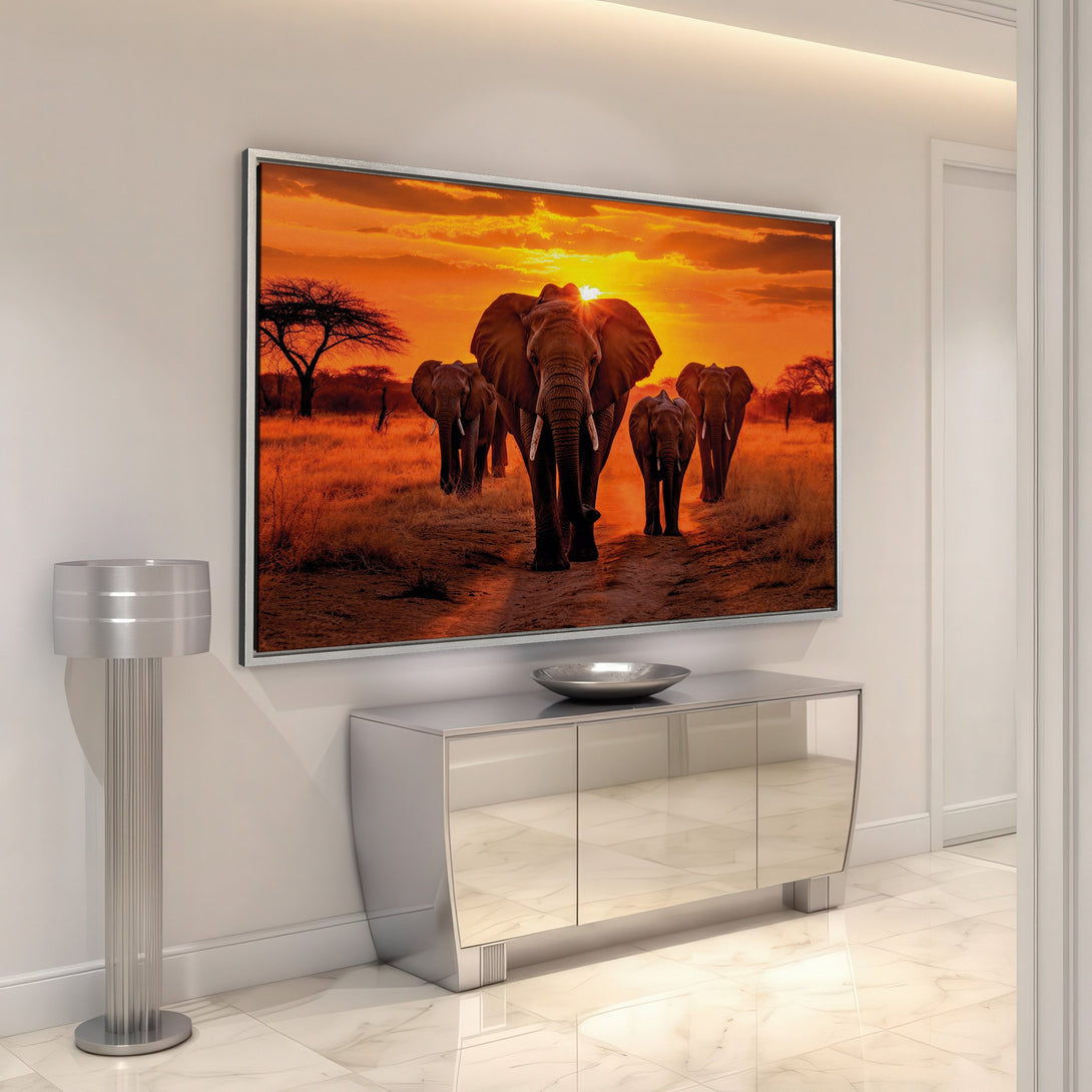 Framed Wall Art of elephants at sunset in warm orange tones. Bring the beauty of the African savanna into your home with this stunning canvas print.