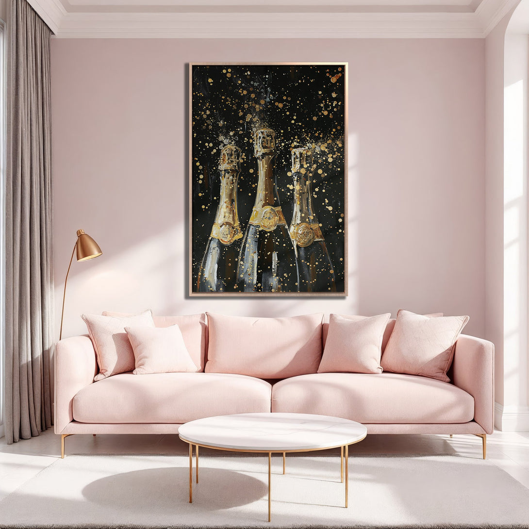 Framed Wall Art of champagne bottles with gold accents on a black background, set in a pink and gold interior. Modern, elegant decor.