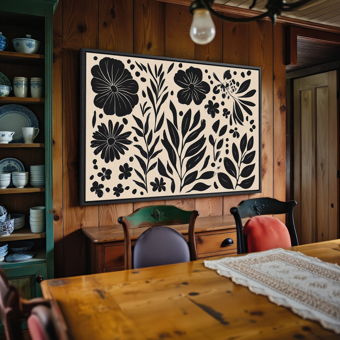 Framed Wall Art: Black and cream floral design canvas print. Modern botanical art in a cozy dining room setting. Perfect for adding style!