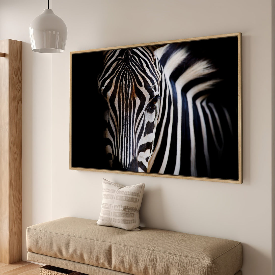 Framed Wall Art featuring a striking zebra portrait. Modern, monochrome style with black, white, and tan color palette. Perfect for adding a touch of nature to your decor.