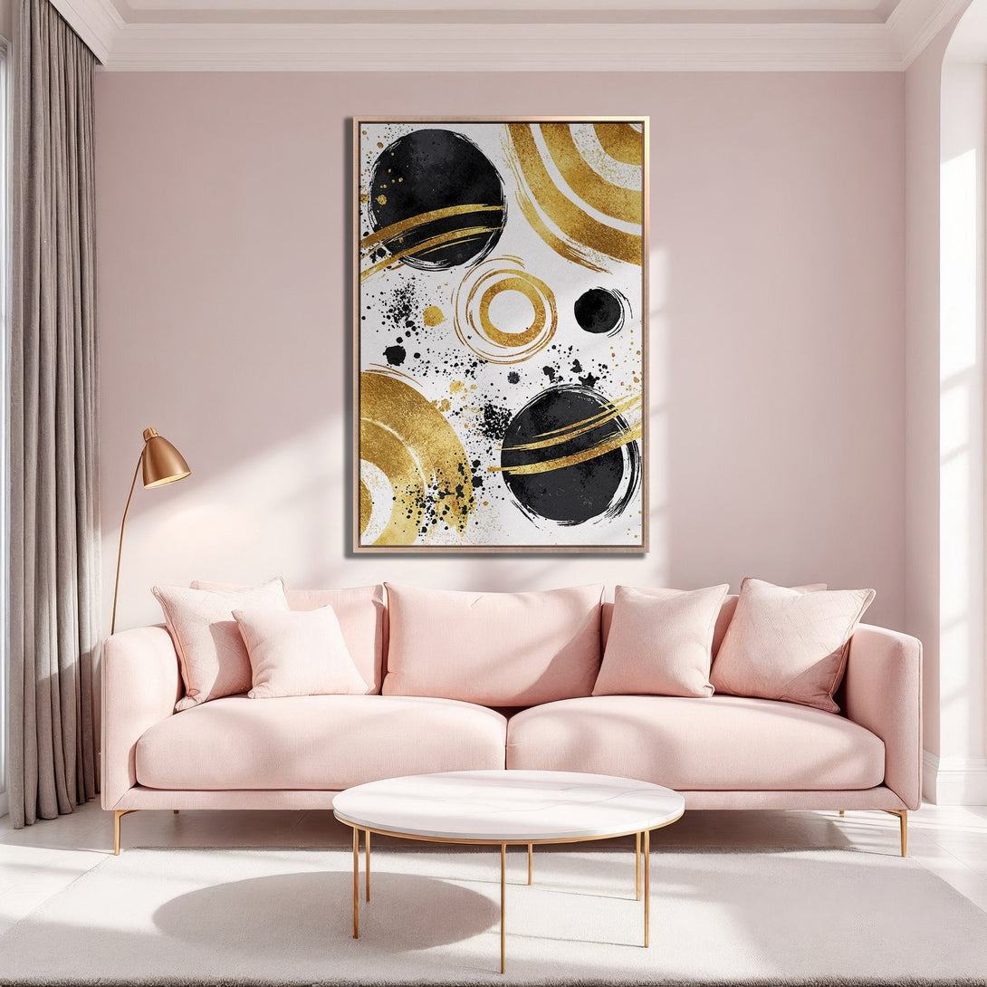 Framed Wall Art featuring abstract gold and black circles. Modern art canvas print in a blush pink interior, perfect for adding a touch of elegance.