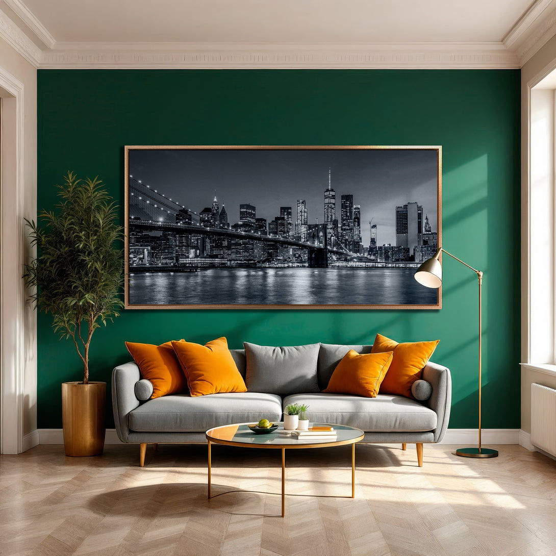 Framed Wall Art of NYC skyline in a modern interior. Black and white cityscape with a gold frame, set against a green wall.