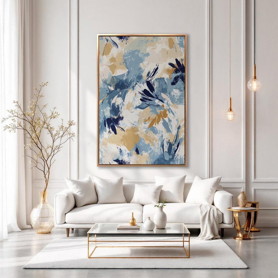 Framed Wall Art: Abstract floral art in blue, gold, and cream tones. Modern canvas print adds elegance to a living room interior. Shop now!
