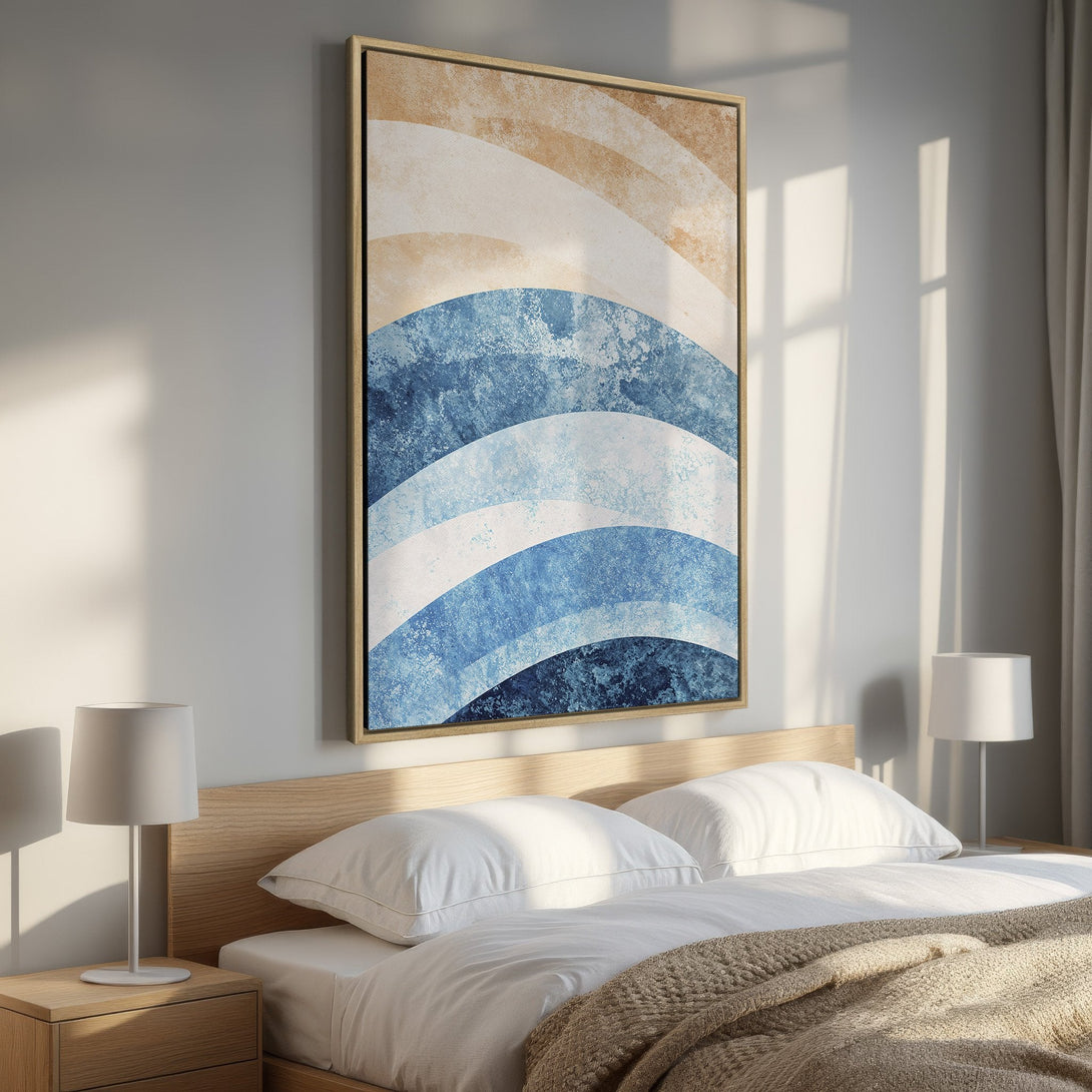 Framed Wall Art featuring abstract blue and beige waves. Modern art canvas print adds a touch of coastal style to any bedroom decor.