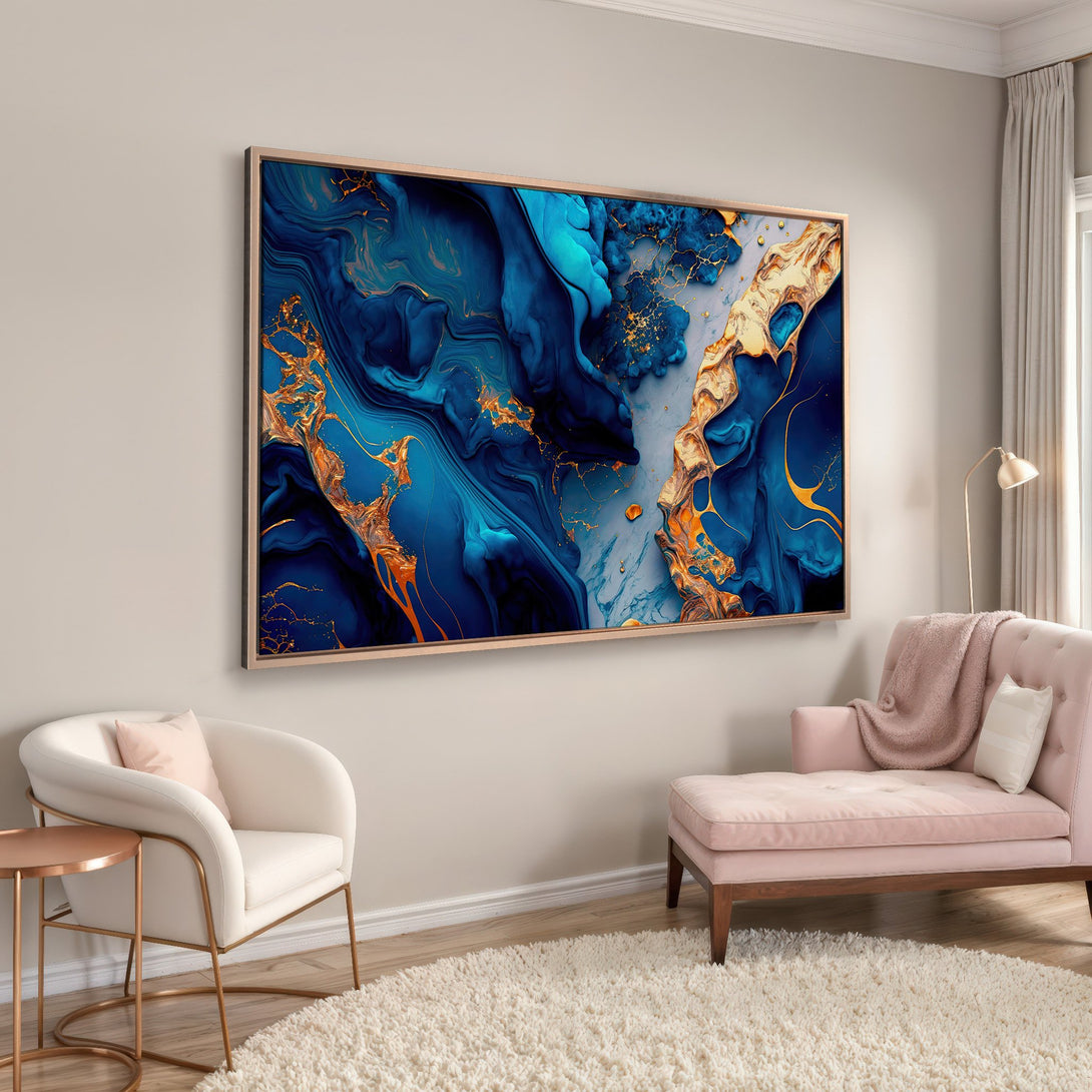 Framed Wall Art: Abstract blue and gold canvas print. Modern art in a living room with a pink sofa. Enhance your home decor with this stunning piece.