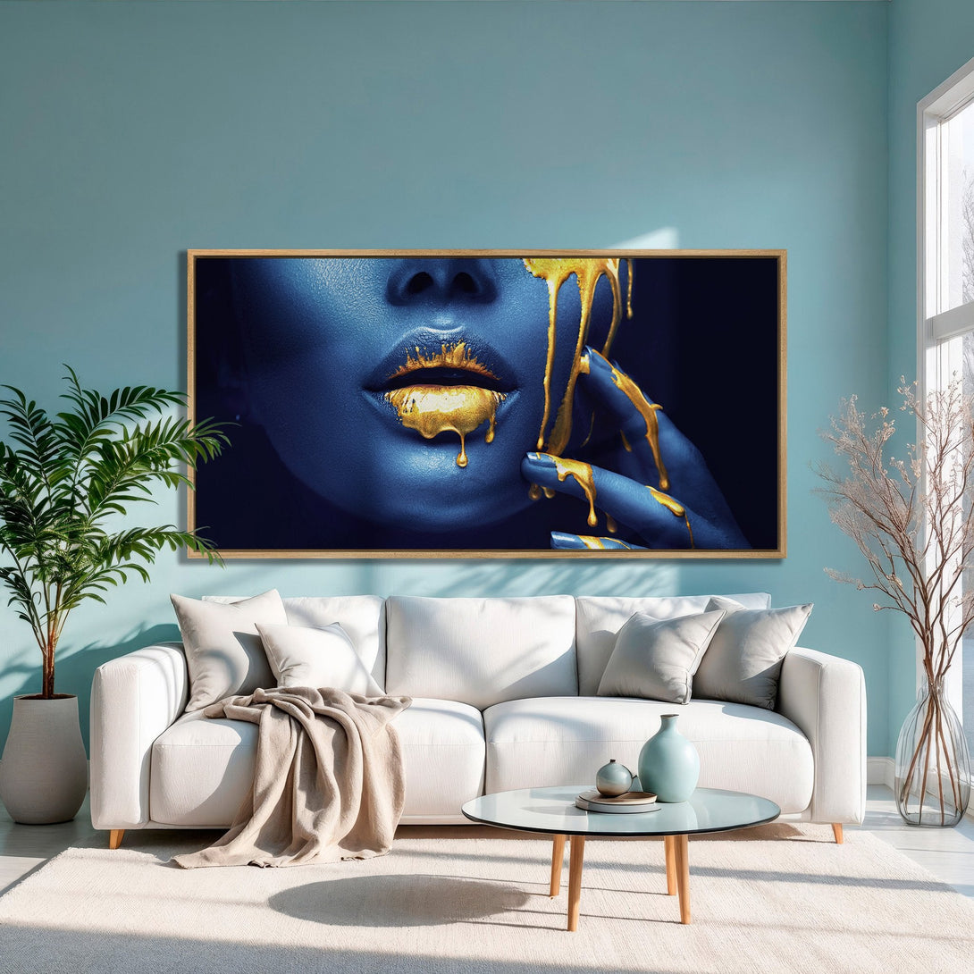 Framed Wall Art featuring a woman's face with gold accents, in a modern interior with a blue and gold color palette. Elevate your space!