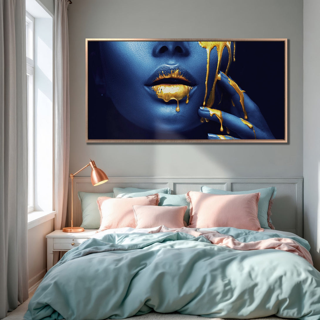 Framed Wall Art: Blue face with gold dripping paint. Modern art print in a bedroom with teal and pink decor. Add artistic flair to your space!