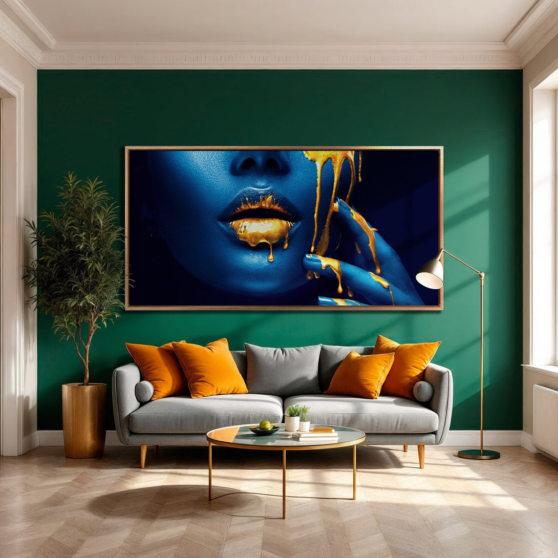 Framed Wall Art featuring a close-up of a face with blue skin and gold dripping paint. Modern art with a bold blue and gold color palette.