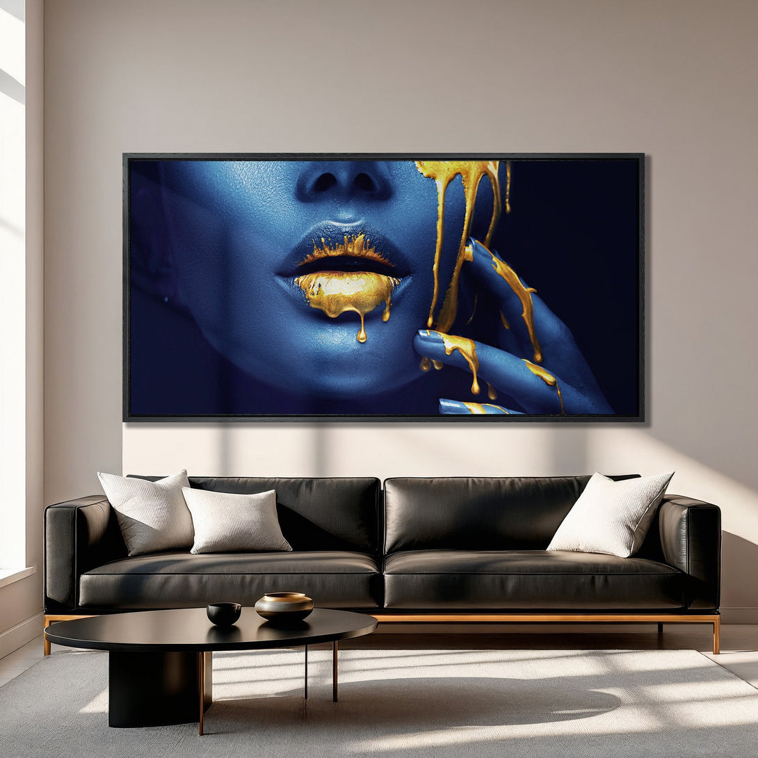 Framed Wall Art featuring a woman with blue skin and gold dripping paint. Modern art in a blue and gold color palette, perfect for home decor.