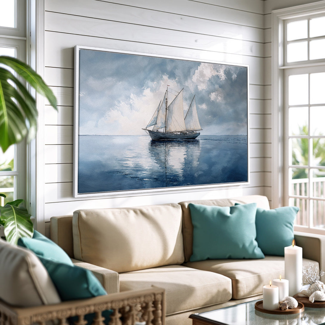 Framed Wall Art: Watercolor sailboat print in blue and gray tones. Coastal style art adds a serene touch to any living room. Perfect nautical decor.