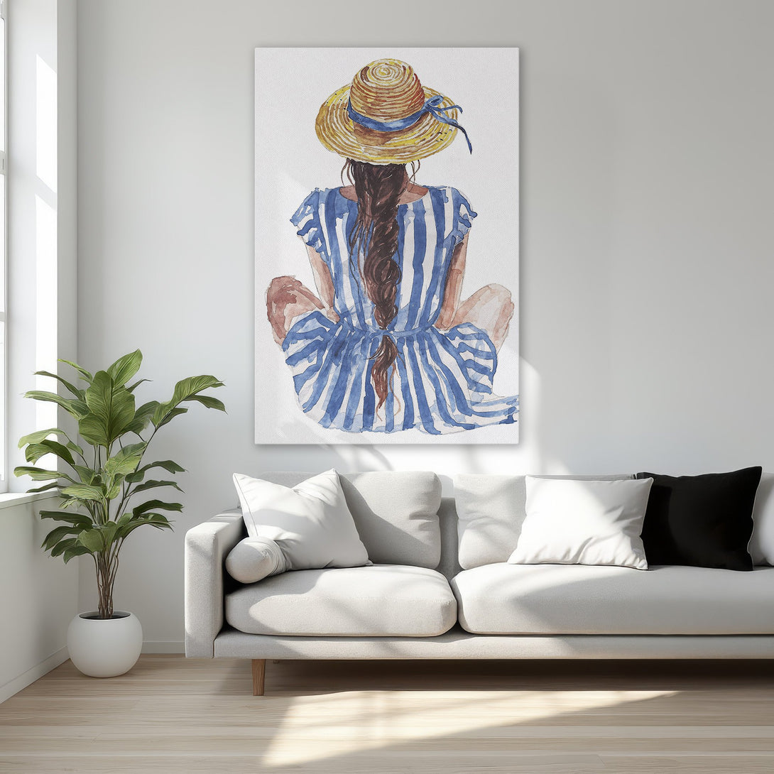 Framed Wall Art featuring a watercolor illustration of a woman in a hat and blue striped dress. Neutral tones with pops of blue. Perfect for coastal decor.