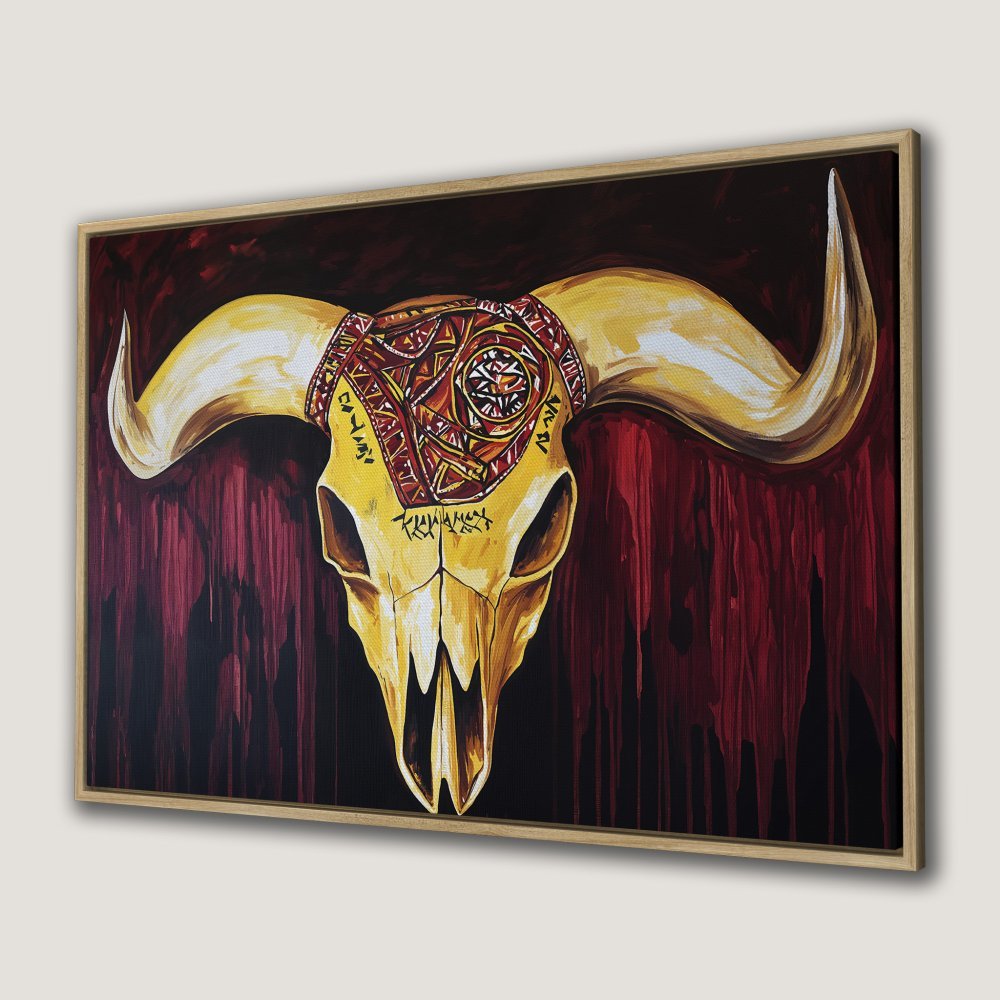 Framed Wall Art: Tribal bull skull canvas print. Bold, modern artwork in warm gold, red, and black tones. Elevate your space with unique wall decor.