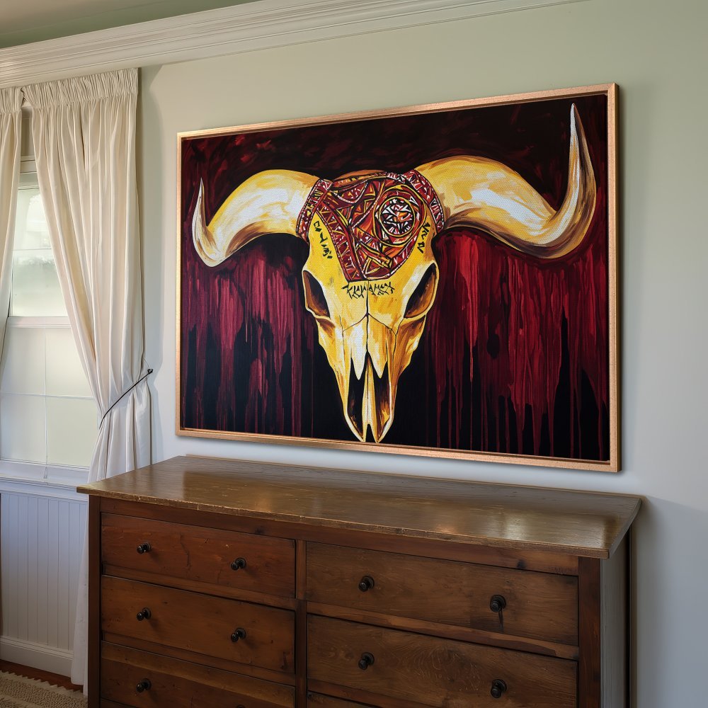 Framed Wall Art: Bold bull skull canvas print in warm red & gold tones. Perfect statement piece for rustic or bohemian decor. Shop now!