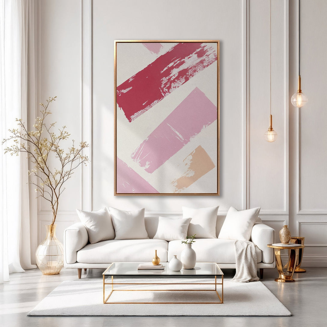 Framed Wall Art featuring abstract brushstrokes in pink and red hues. Modern canvas print adds a pop of color to a stylish living room.