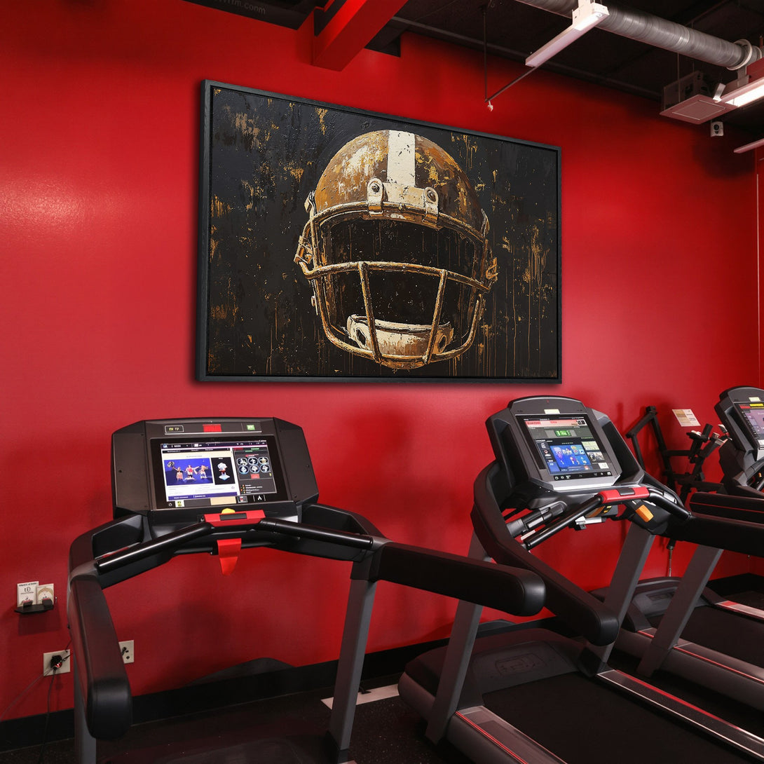 Framed Wall Art: Abstract football helmet art in gold and black, displayed in a red gym setting. Modern decor for sports enthusiasts.