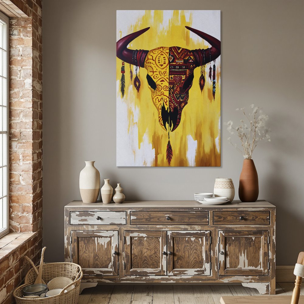 Framed Wall Art: Tribal bull skull canvas print in a dining room. Warm yellow and red color palette, perfect for boho home decor.