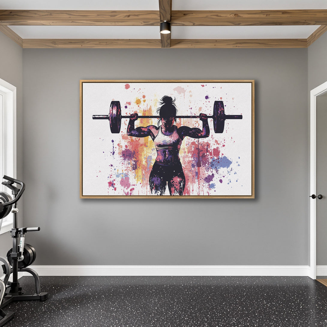 Framed Wall Art featuring a weightlifting woman in a watercolor style with a vibrant, colorful splash palette. Perfect for gym decor.