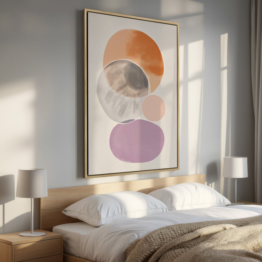 Framed Wall Art in a bedroom. Abstract watercolor circles in warm orange, brown, and purple hues. Modern art for a stylish interior.