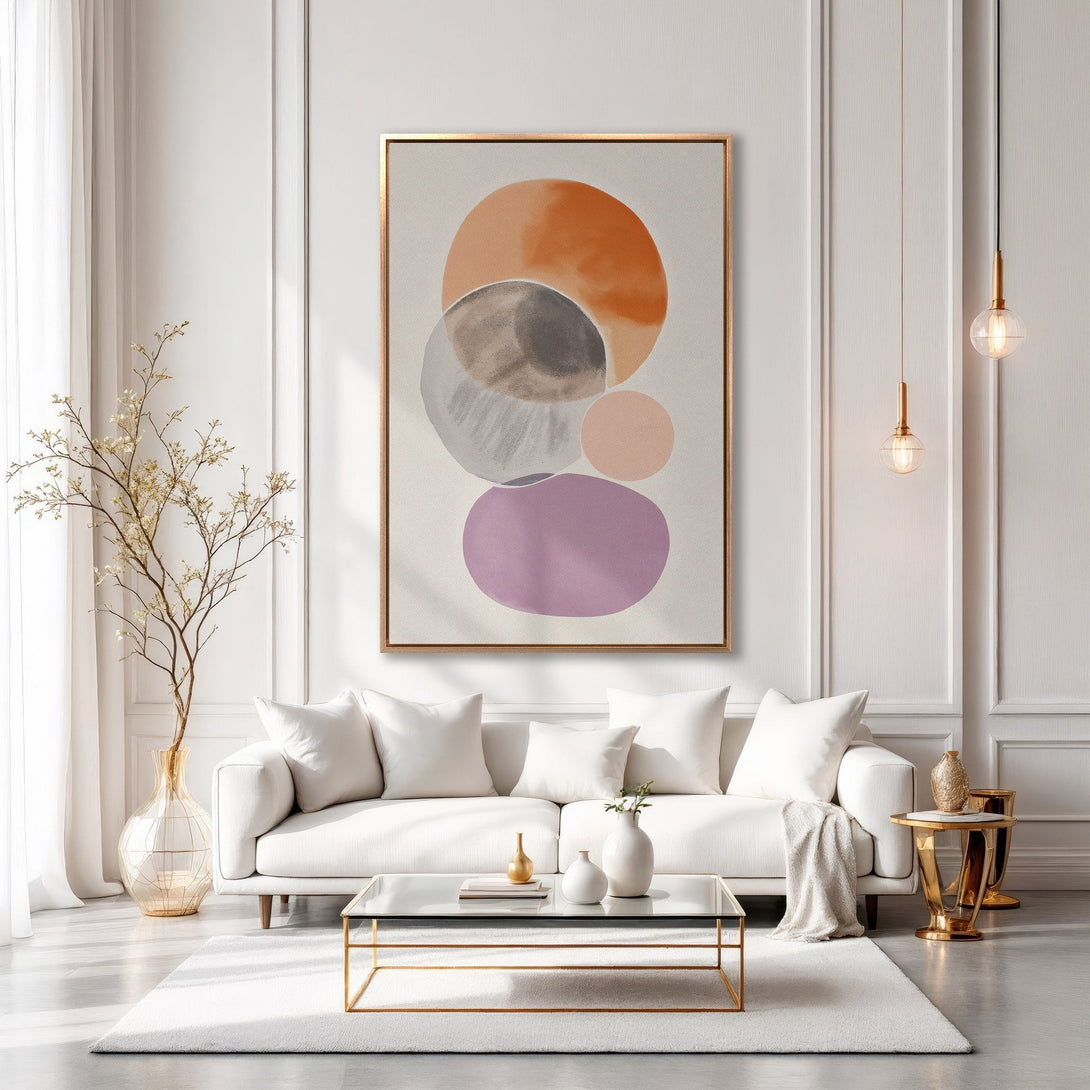 Framed Wall Art: Abstract circles in warm orange, gray, and purple hues. Modern art canvas print adds a pop of color to a neutral living room.