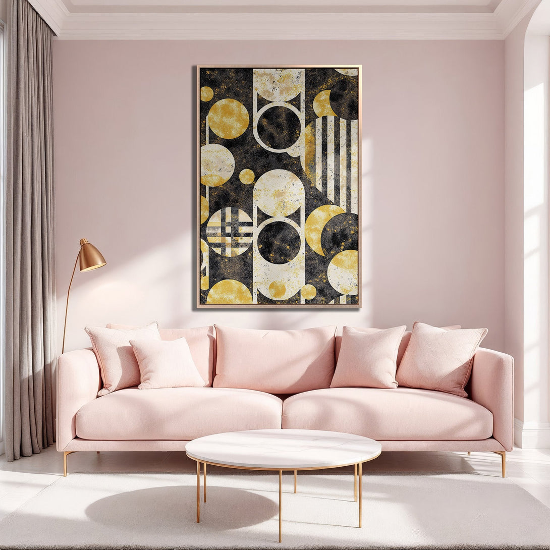Framed Wall Art: Abstract geometric design in black, gold, and white. Modern art print displayed above a pink sofa in a stylish interior setting.