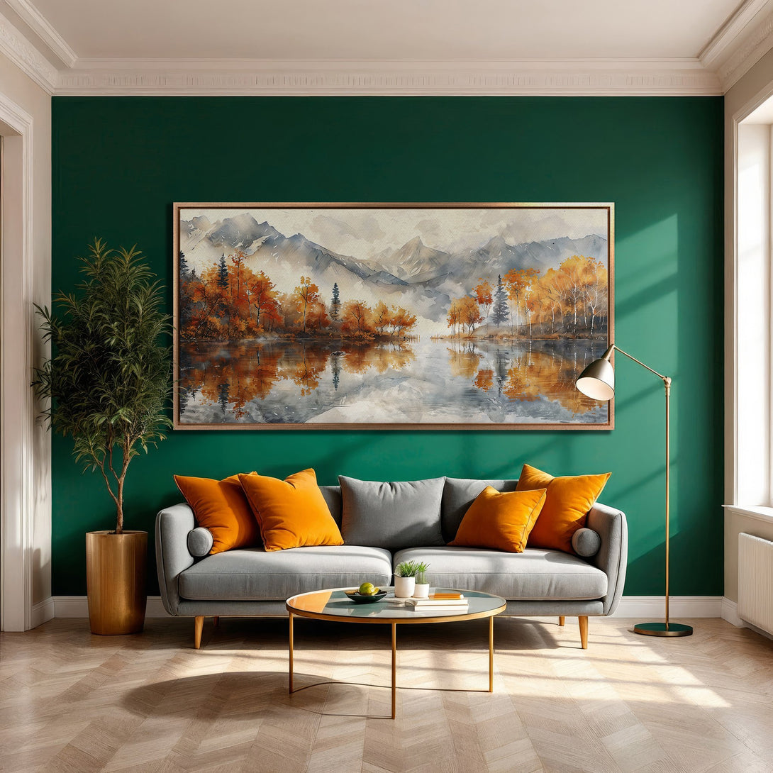 Framed Wall Art: Watercolor landscape Canvas Print with autumn trees & lake. Warm orange & grey tones in a cozy living room setting.