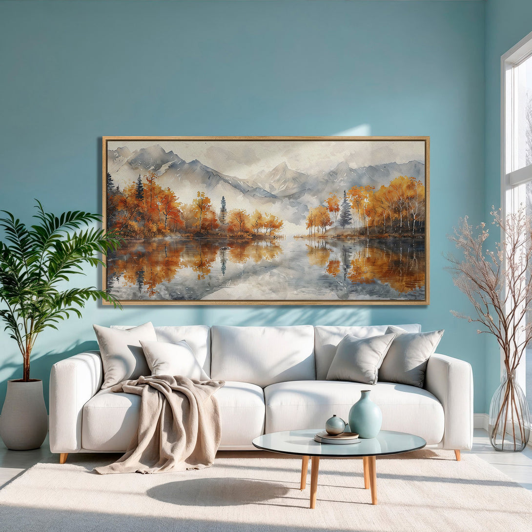 Framed Wall Art: Watercolor landscape Canvas Print with autumn trees and lake. Warm orange, gray, and blue color palette for a cozy living room.