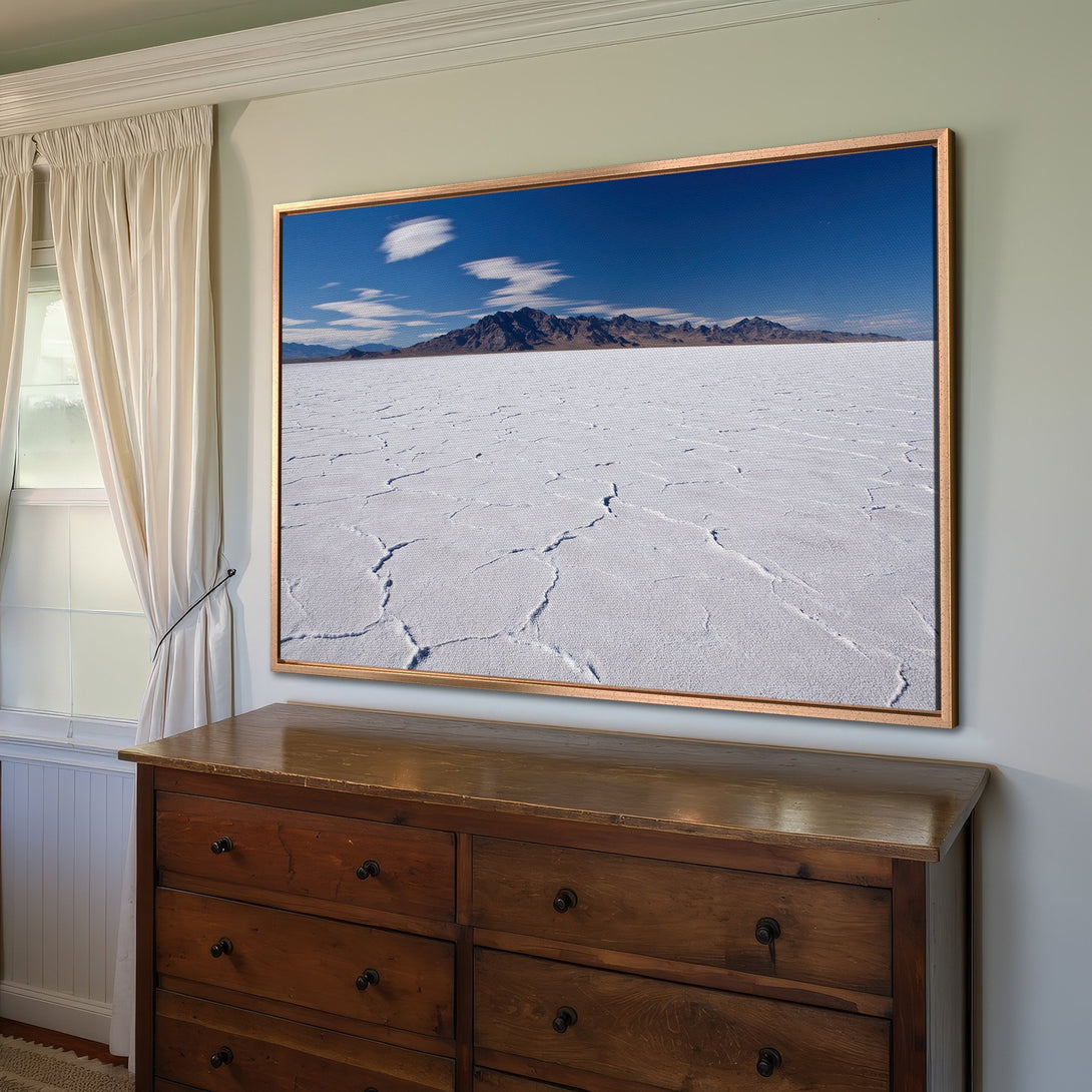Framed Wall Art Canvas Print showcasing a vast salt flat landscape with blue sky and mountains. Modern, minimalist style with a cool, natural color palette.